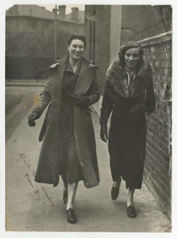 Ivy Russell and unidentified woman on sidewalk